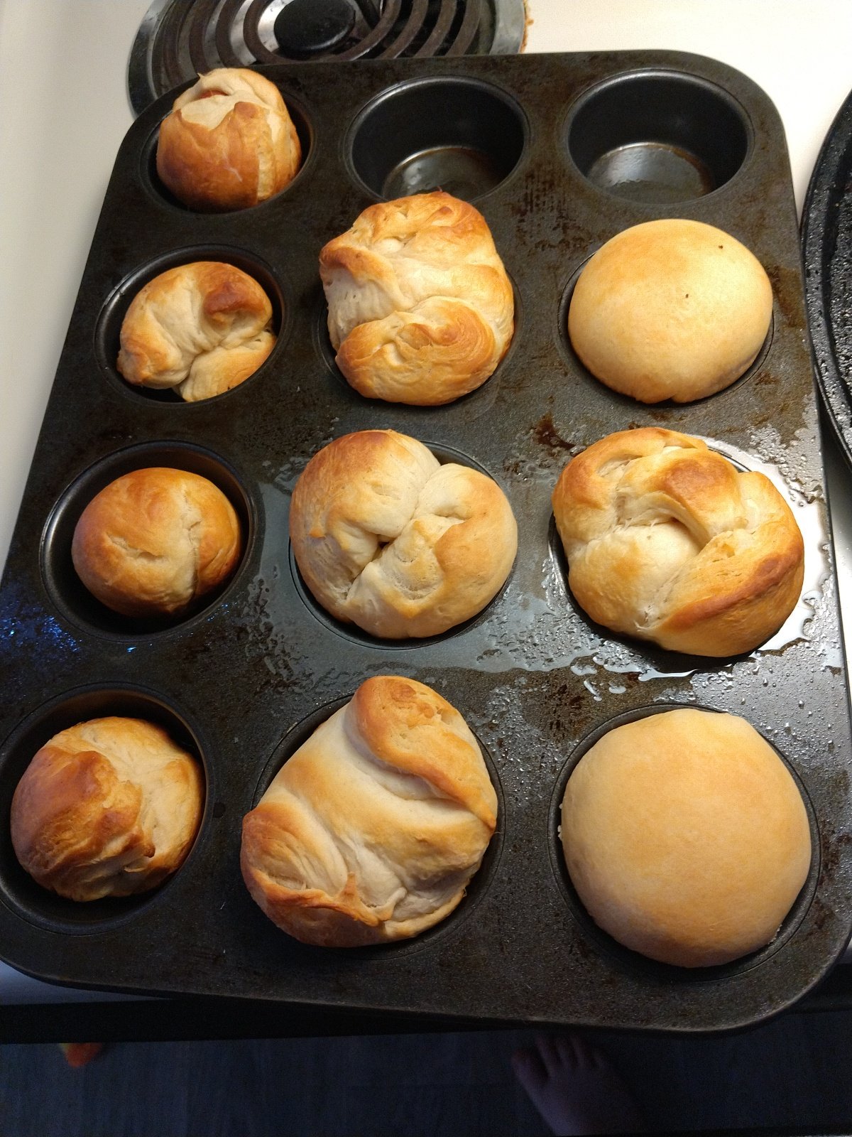 Golden dinner rolls baked in a muffin tin