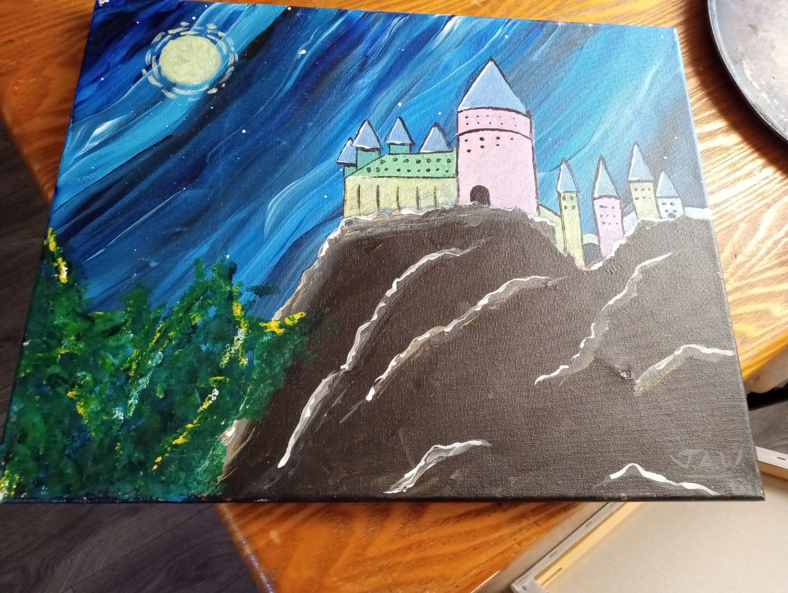 Original painting of a pastel castle on a rocky cliff beneath a moonlit blue night sky