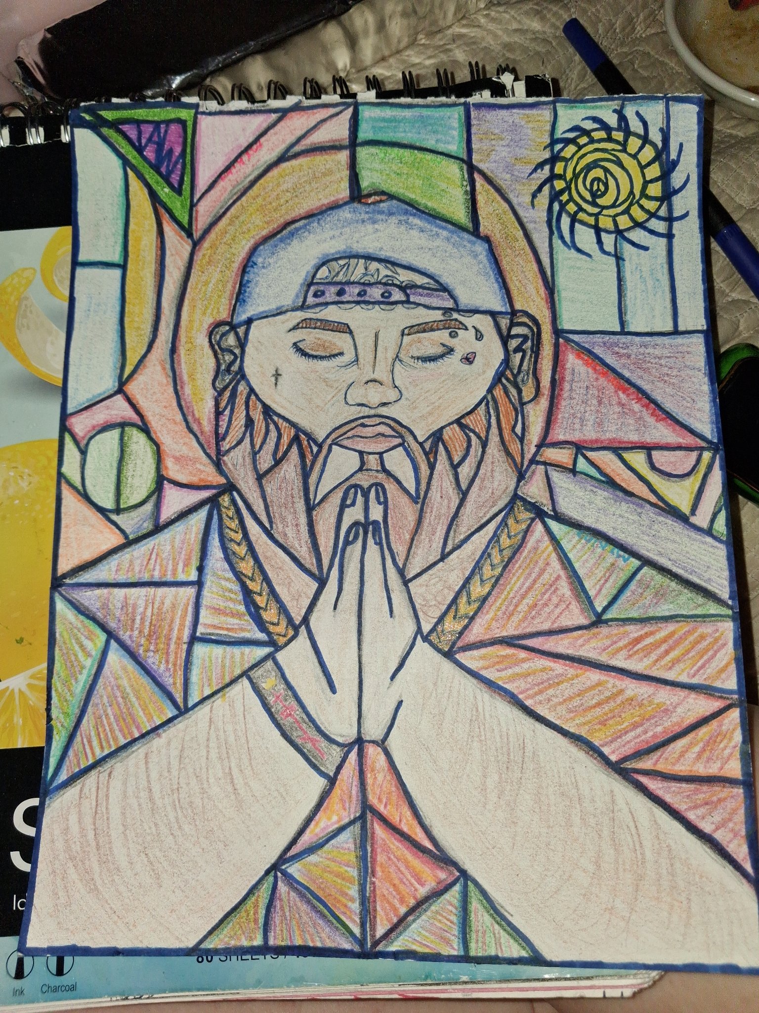 Stained-glass-style colored-pencil drawing of a figure with hands folded in prayer